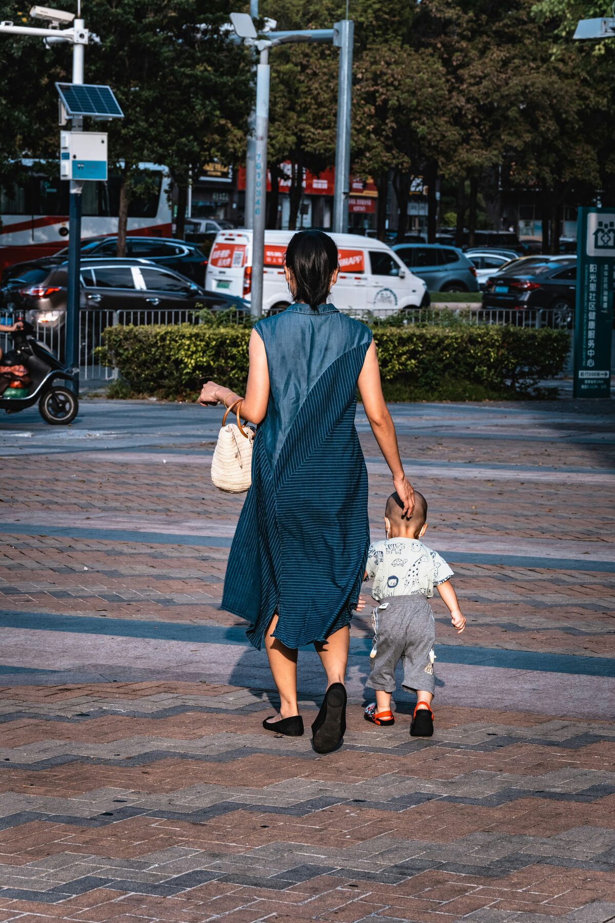 A mother walking with her stroller through downtown Raleigh